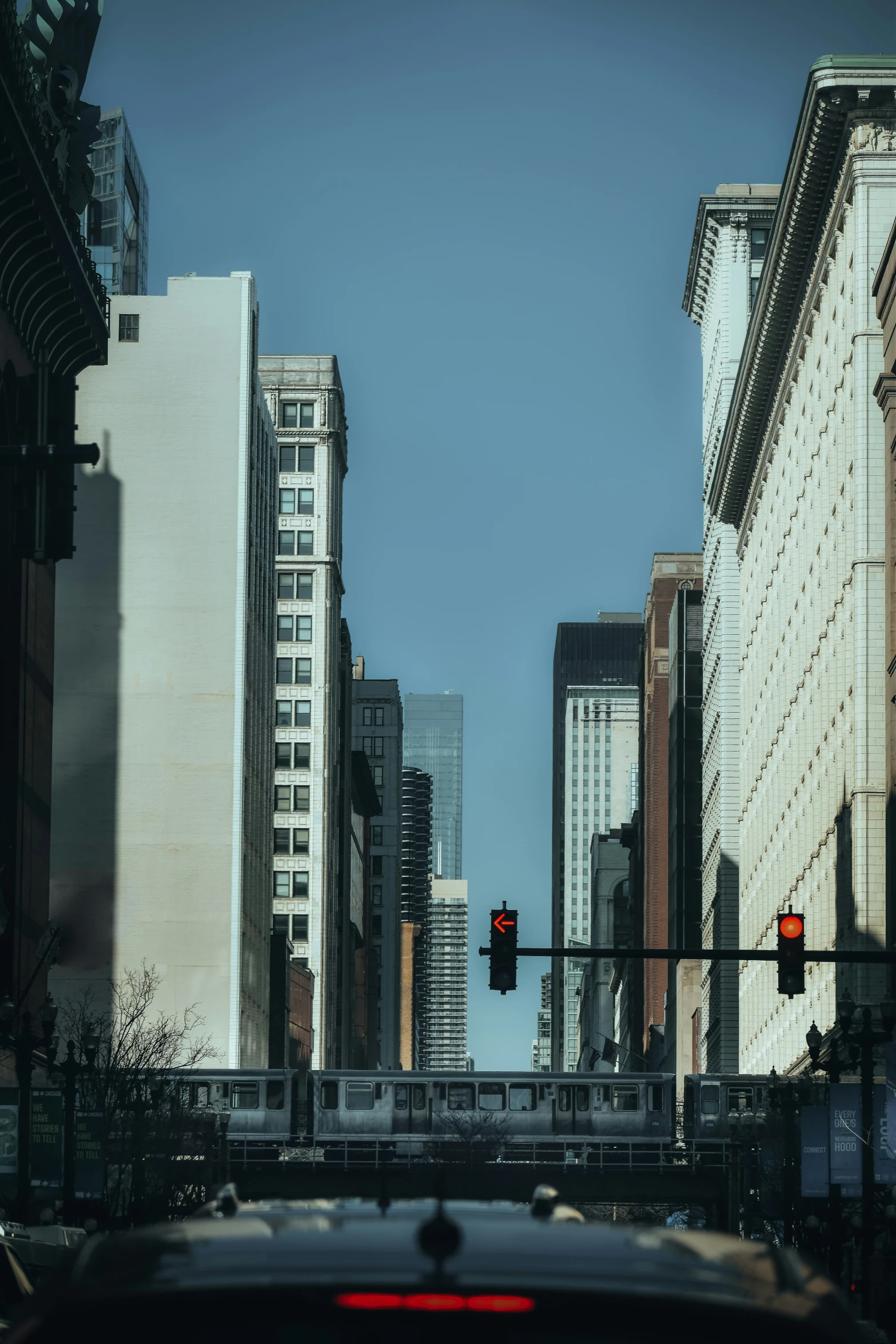 street lights on poles along an intersection with buildings in the background