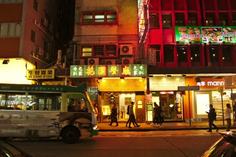 city street at night time with neon lit building
