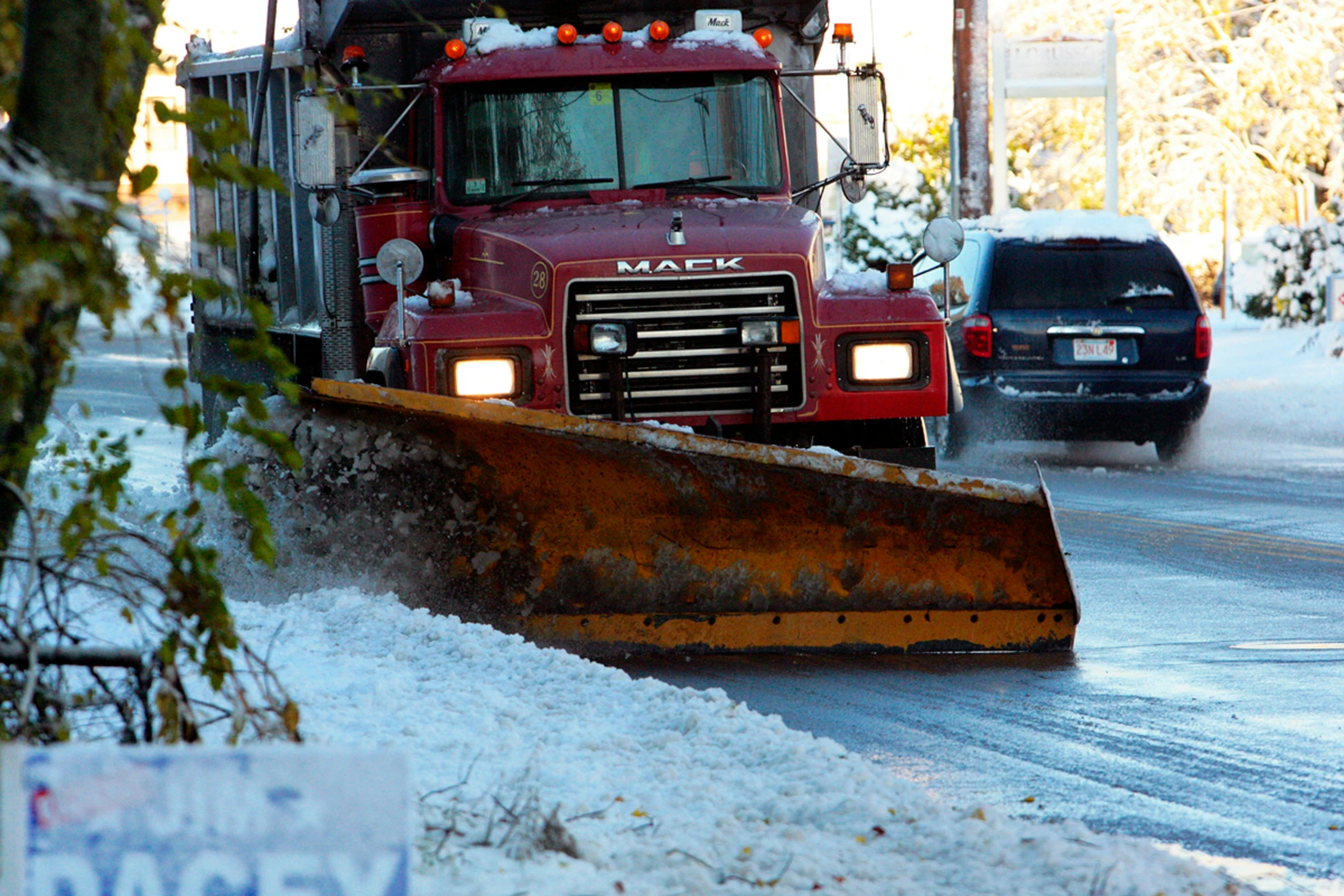 a snowplow has stopped at a stop sign on the highway