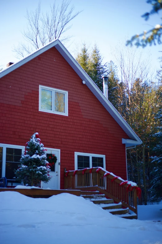 a red building that has a porch covered in snow