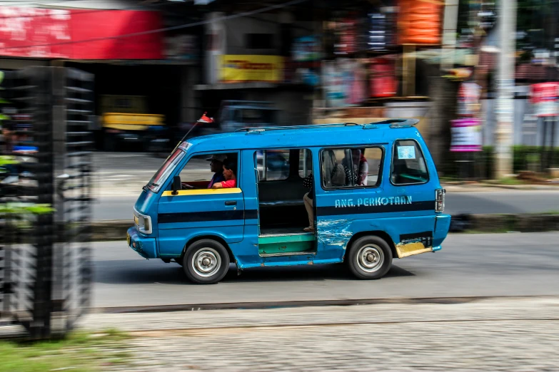 an electric minibus driving on a city street