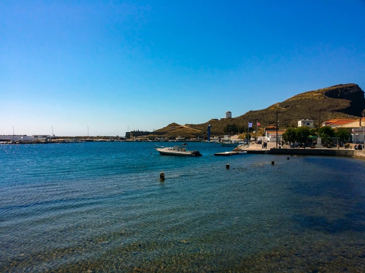 people are bathing in the water off a beach