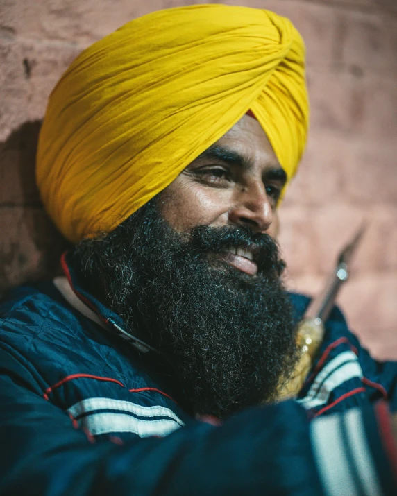 a man with a turban on holding some scissors