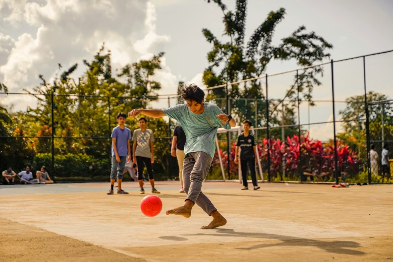 boys playing ball outside in the sun