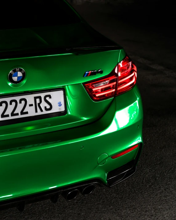 an emerald green bmw with a white license plate