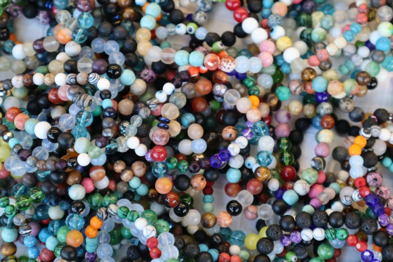 lots of colorful beads are scattered around each other