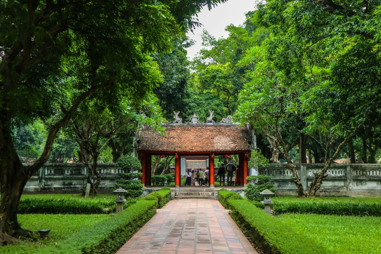 an old pavilion is surrounded by beautiful green trees and shrubs