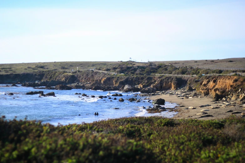 there are many people on the beach near the water