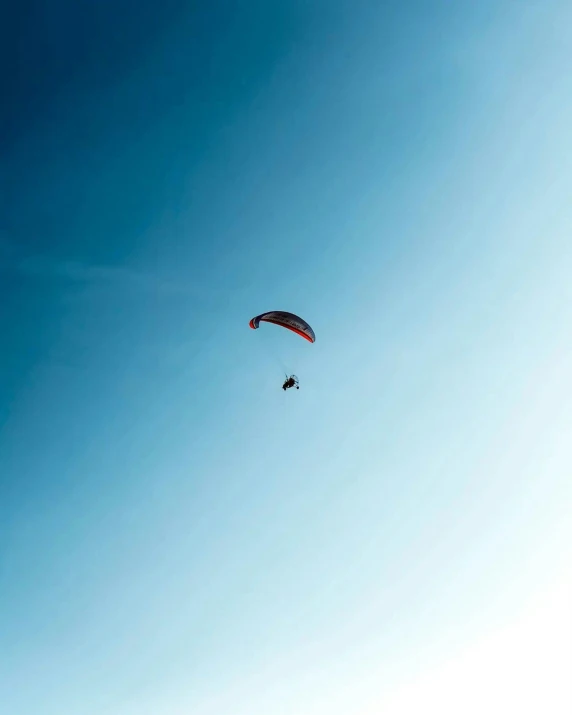 two people parasailing in the blue sky