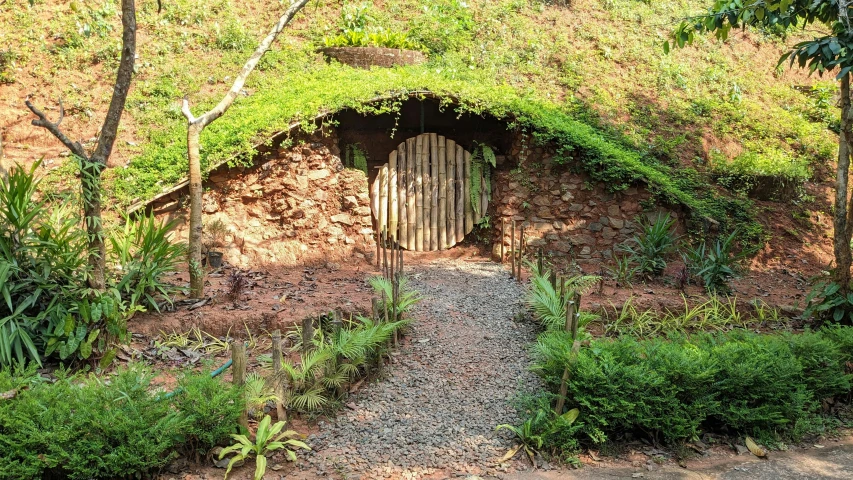 a garden with a tunnel for people to walk through