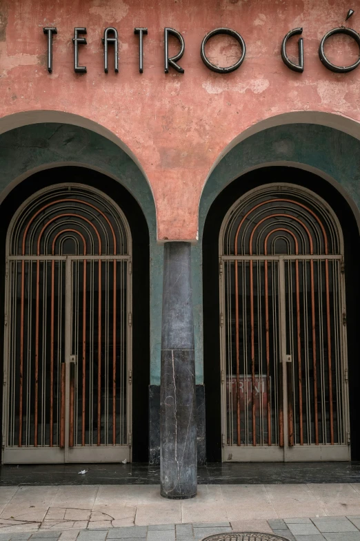 two double doors in an old building with metal bars