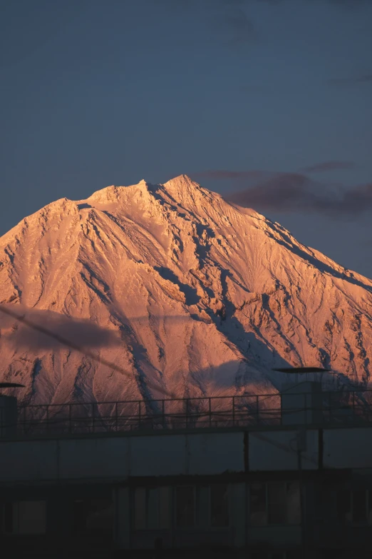 the mountains have been illuminated by the sun setting