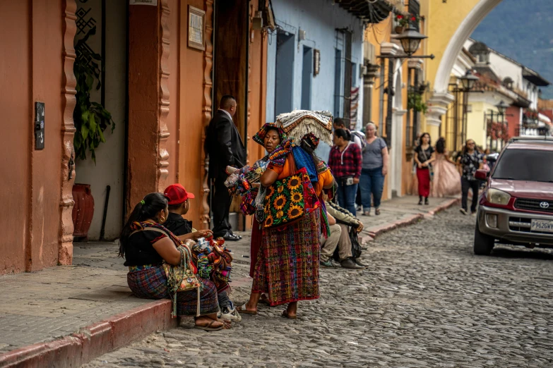 people line up on the street with colorful clothing