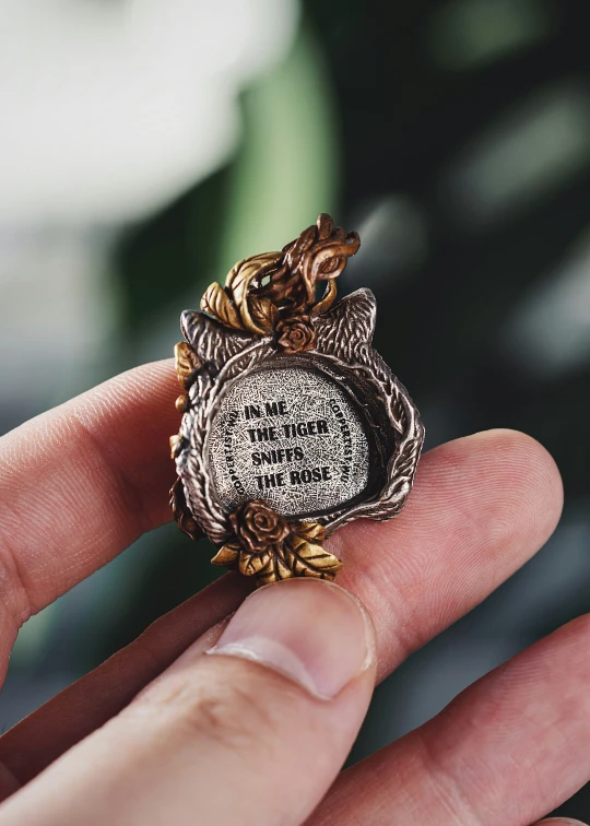 a small owl figurine sitting in someone's hand