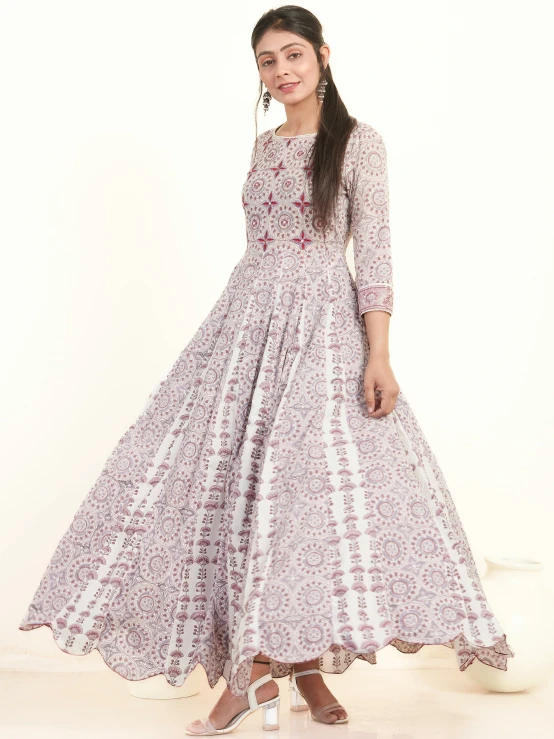 woman in long dress on white background wearing sandals