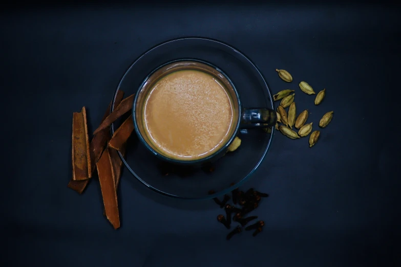 a cup of coffee sitting next to pieces of bread on top of a saucer