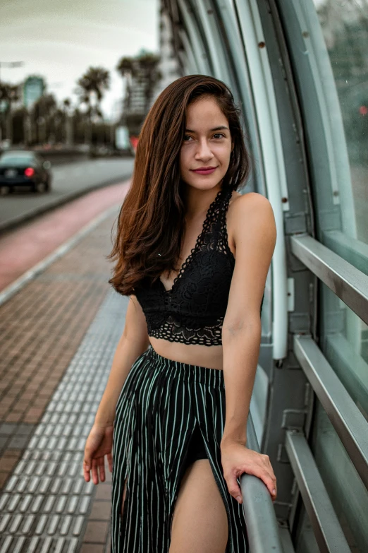 a woman leaning against the side of a building