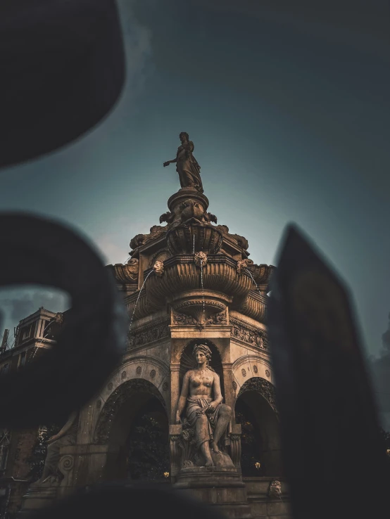 the statue of a man is on a fountain