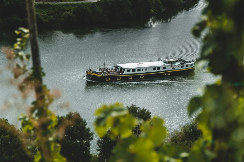 a passenger ferry on a river with people on board