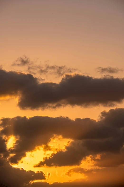 a sunset with an airplane coming in for a landing