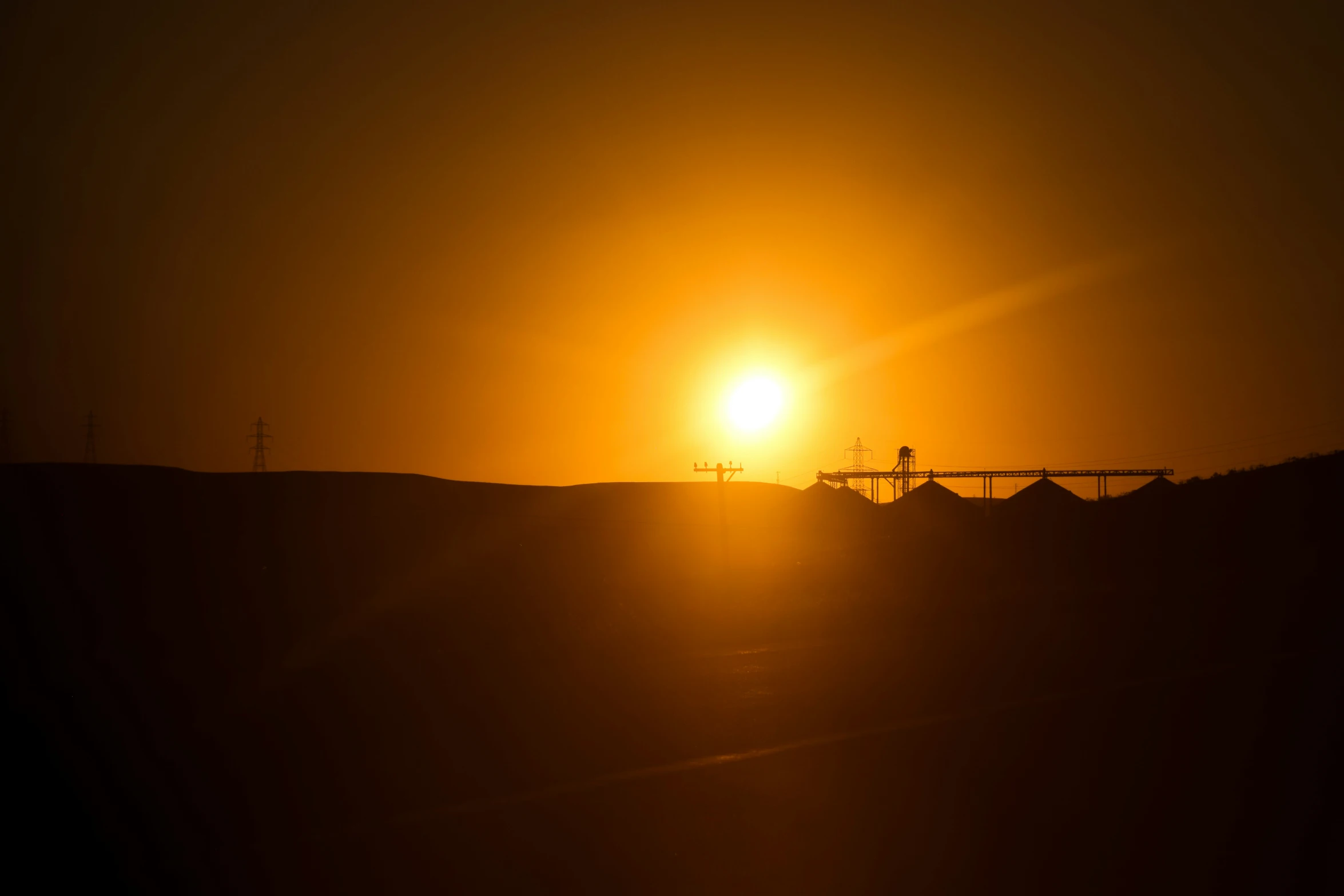 a silhouetted picture of a train as the sun is going down