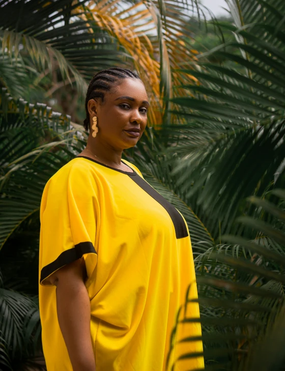 a woman in yellow with black on her shirt