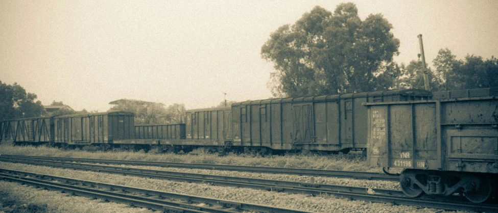 an old po of trains moving in an industrial area