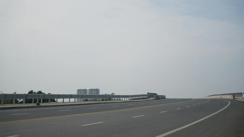 a highway with an empty street and a bridge above it