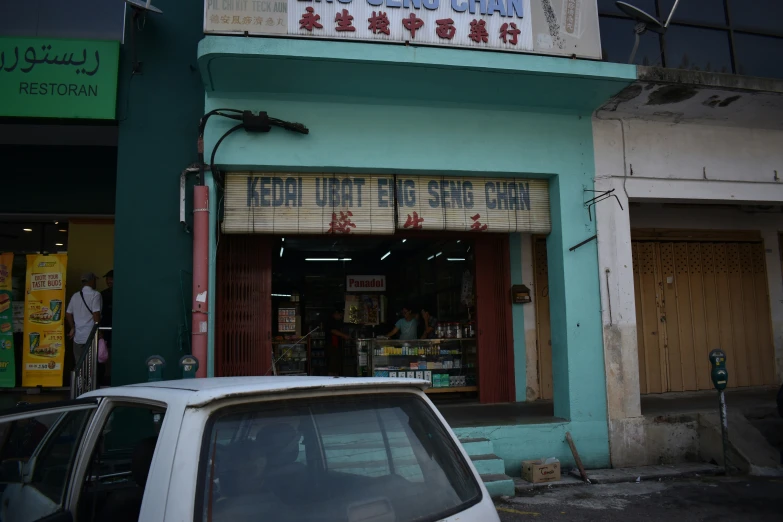 the chinese store has two men looking into it's window
