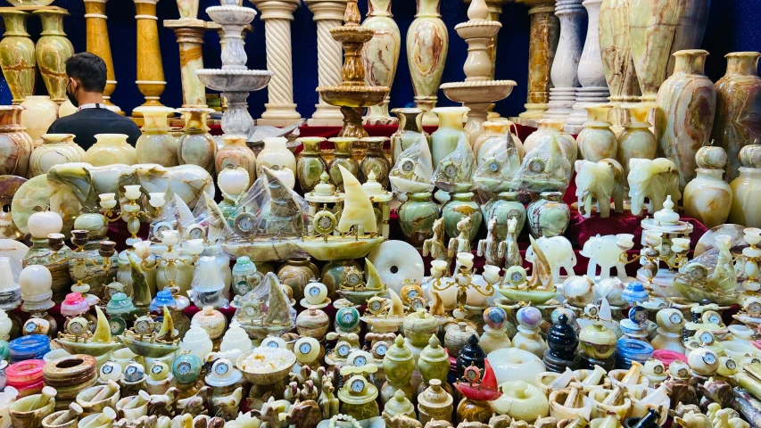 many different colored vases and ornaments are on display