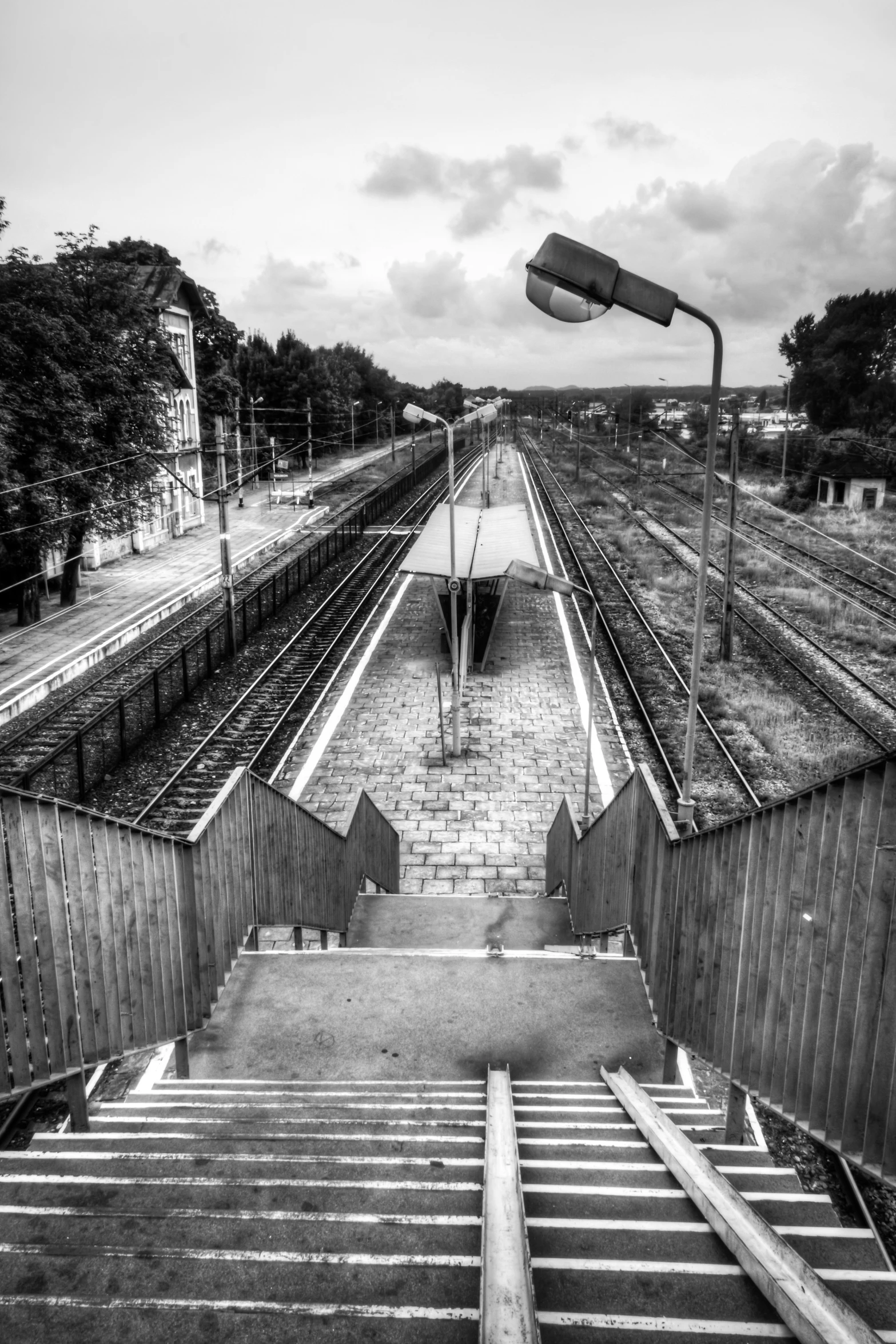 black and white pograph of a staircase going to a train