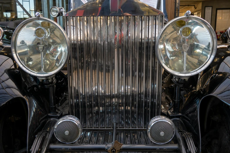 a close up of the front and sides of an antique car