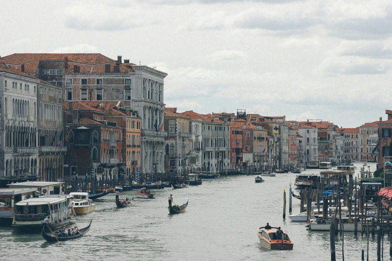 boats going down the river next to buildings