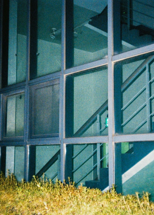 an open window overlooking grass in a building
