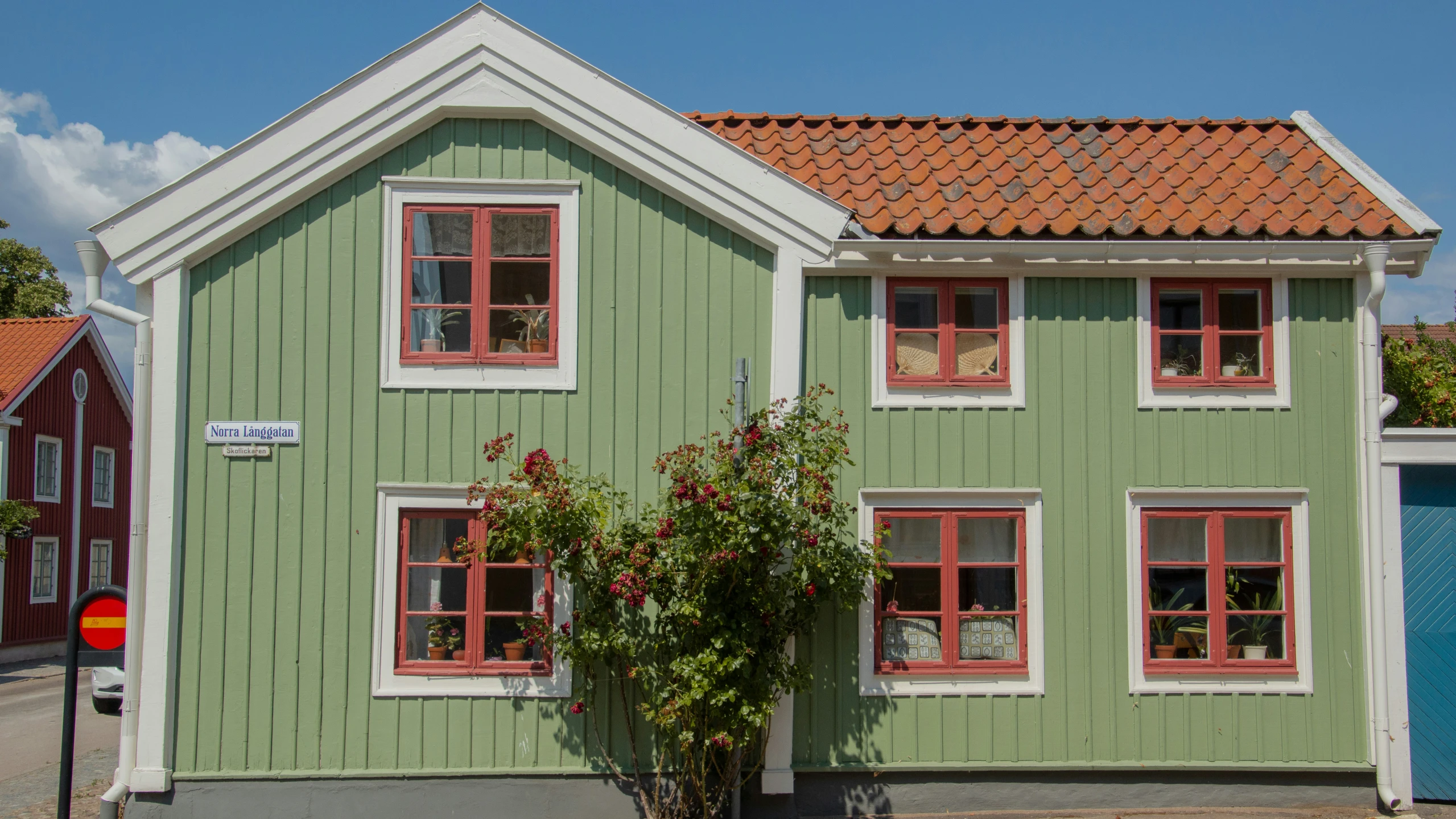 two windows are on the side of an older house