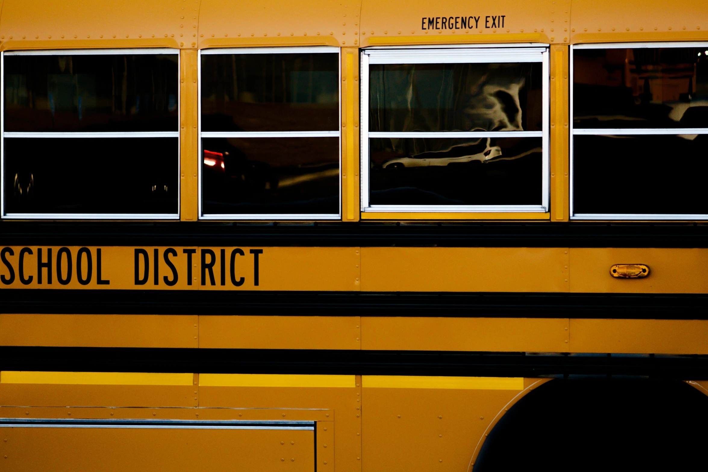 a school bus with its door open next to a building