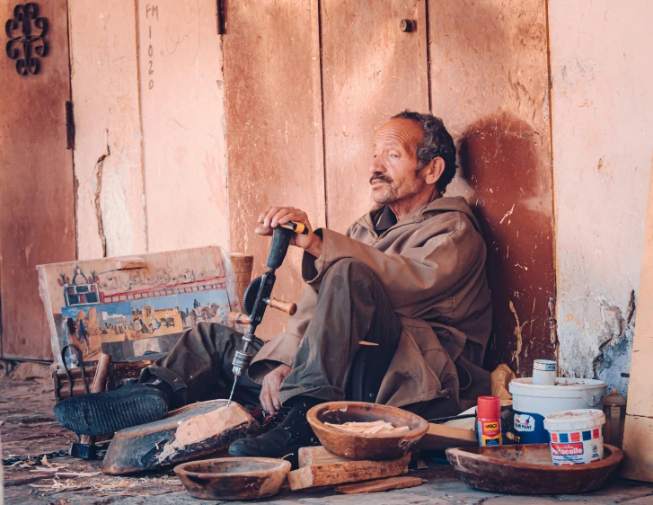 a man that is kneeling down by some sort of soing