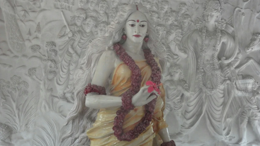 a statue standing in front of a white backdrop