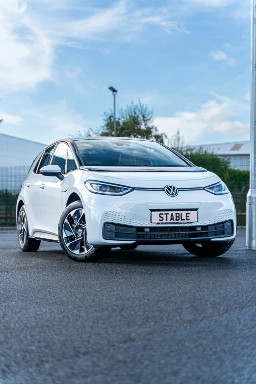 a white electric car parked on the side of a road