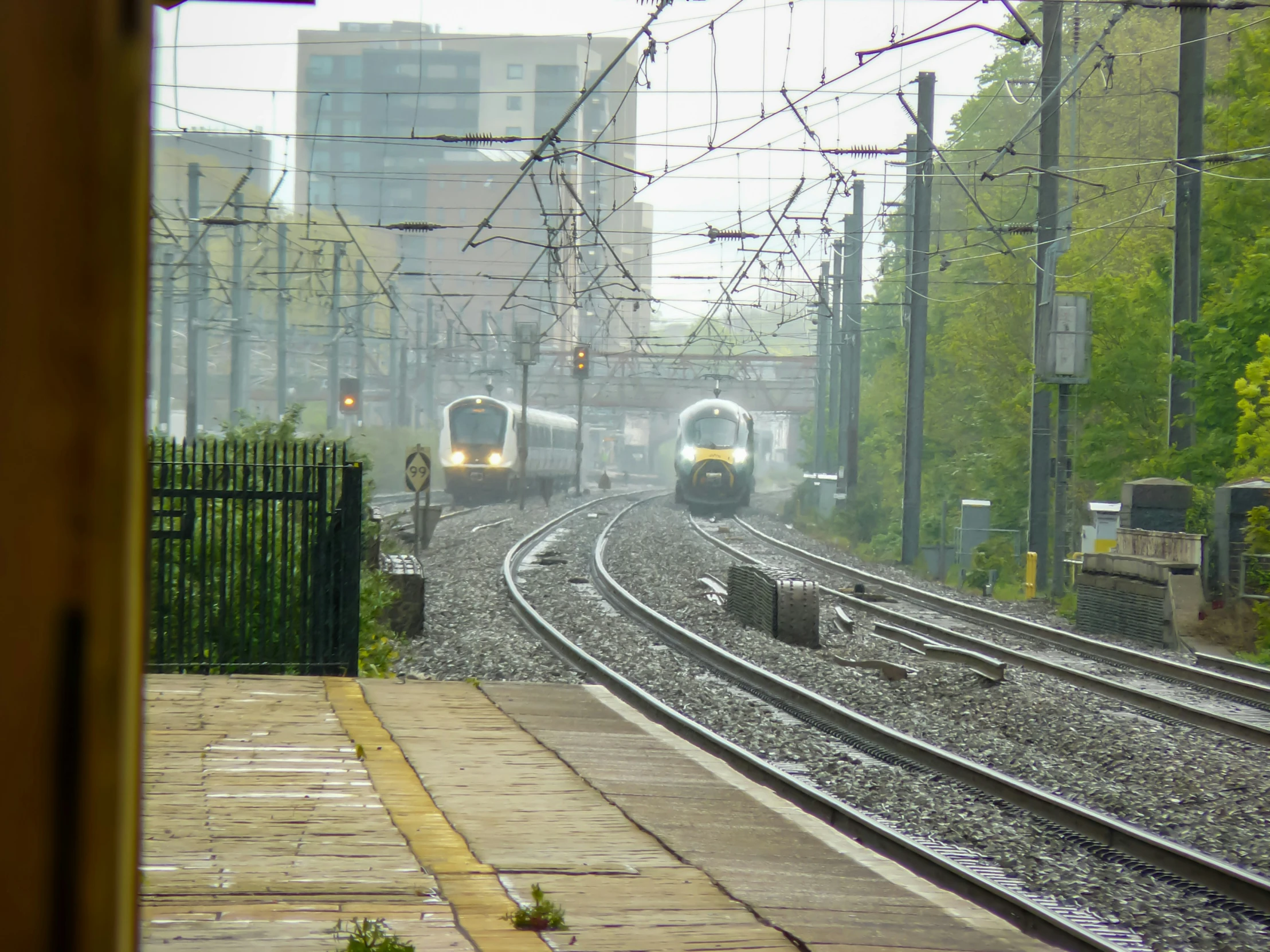 two trains traveling down the railroad tracks