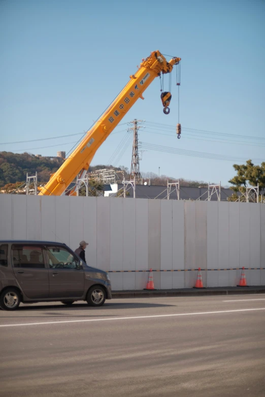 a man is being lifted from the crane of a building