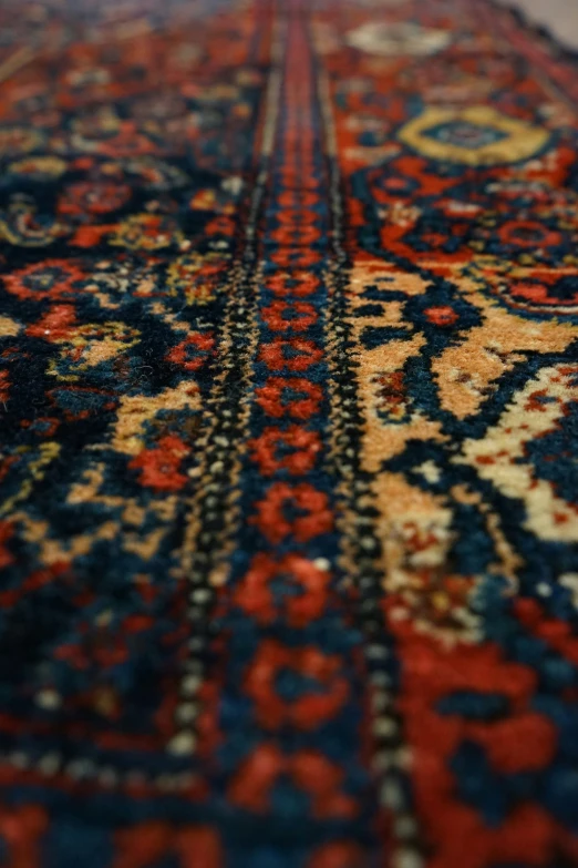 a vintage carpet with lots of colorfully designed design