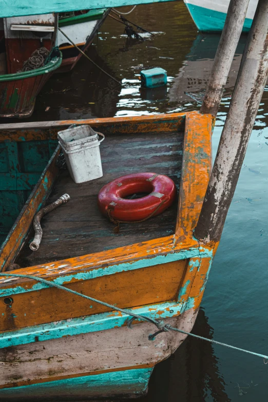 the front end of a boat in water with small life rings