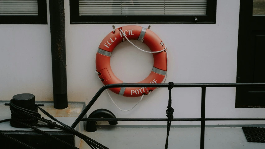 a life preserver hangs on the side of a house