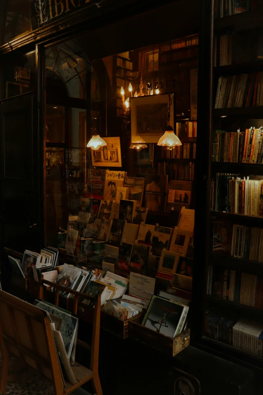 a very dimly lit bookshopp with many books and pictures on the shelves