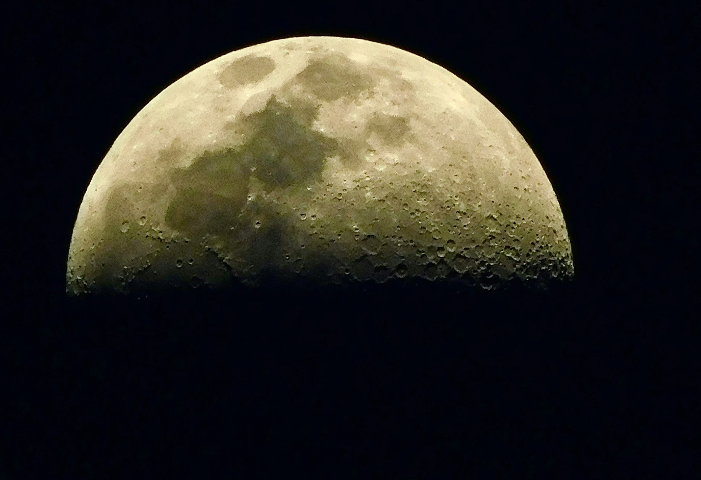 a pograph of the moon taken from the side of a building