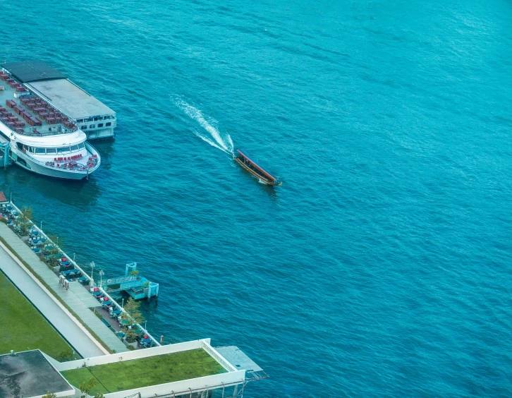 two boats are in the water and some people watch