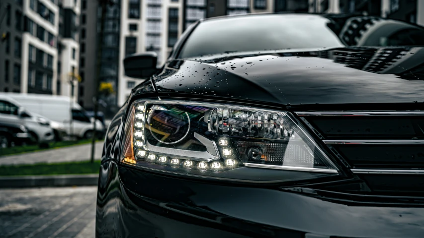 close up on the front headlights of a black car