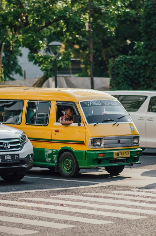 two vans driving in opposite directions on the street