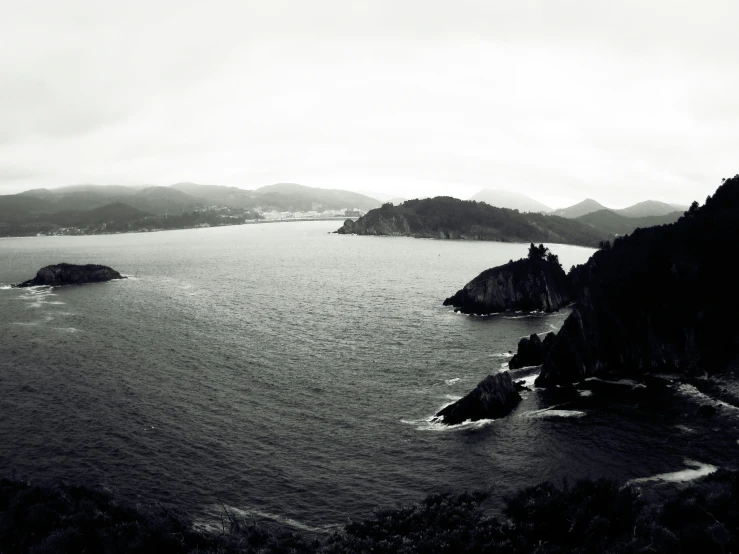 an ocean with mountains in the distance